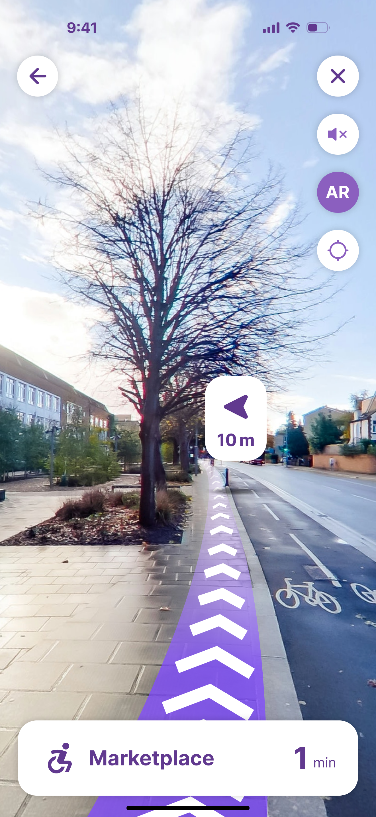 AR view outdoors: a purple chevron path along a tree-lined pavement, a turn-left arrow at 10 m, and Marketplace 1 min in the bottom card