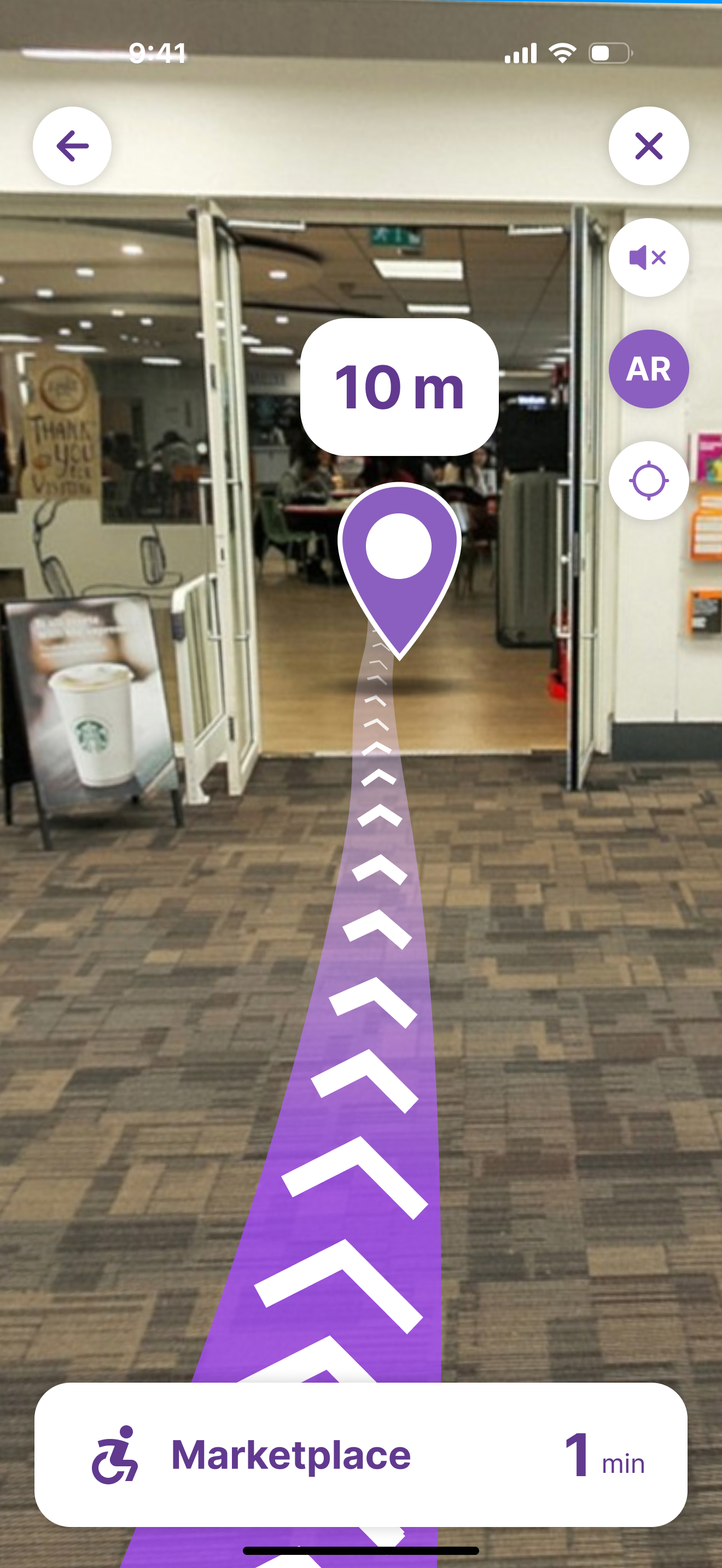 AR view inside the building: a location pin at 10 m over the purple path towards the café area