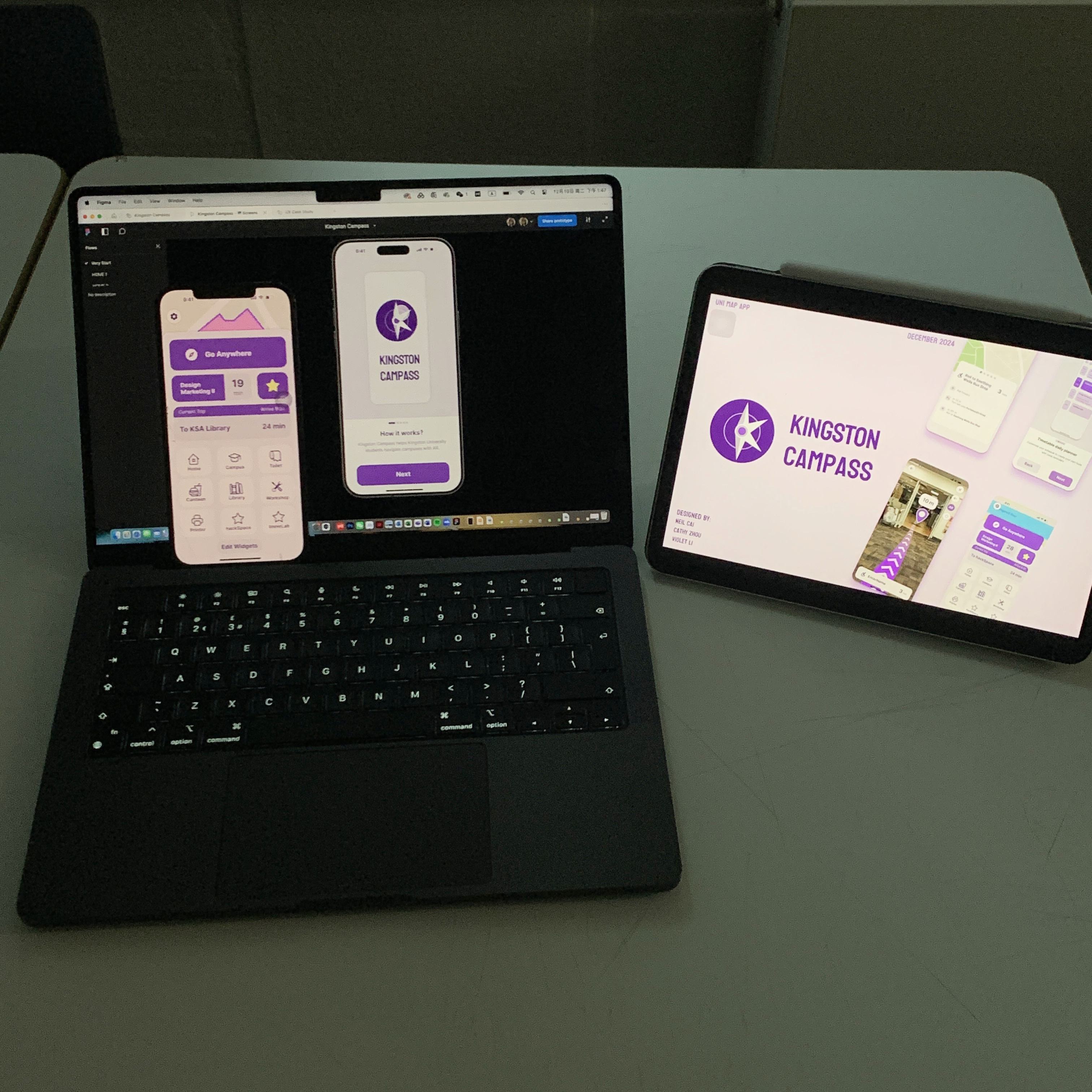 A prototype test set-up on a classroom desk: a laptop showing the Kingston Campass home and splash screens in Figma, beside a tablet showing the project cover